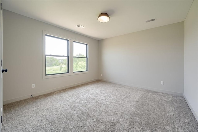 907 Reed Dr, Raymore, MO 64083 - carpeted empty room with baseboards