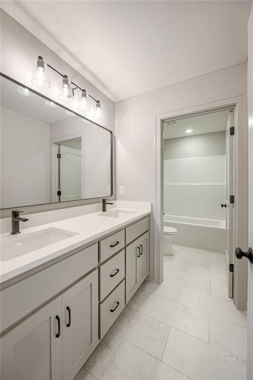 907 Reed Dr, Raymore, MO 64083 - bathroom with double vanity and toilet