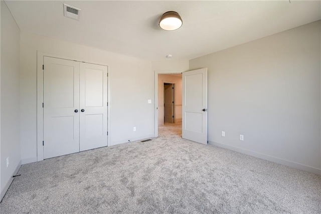 907 Reed Dr, Raymore, MO 64083 - unfurnished bedroom with carpet floors and a closet