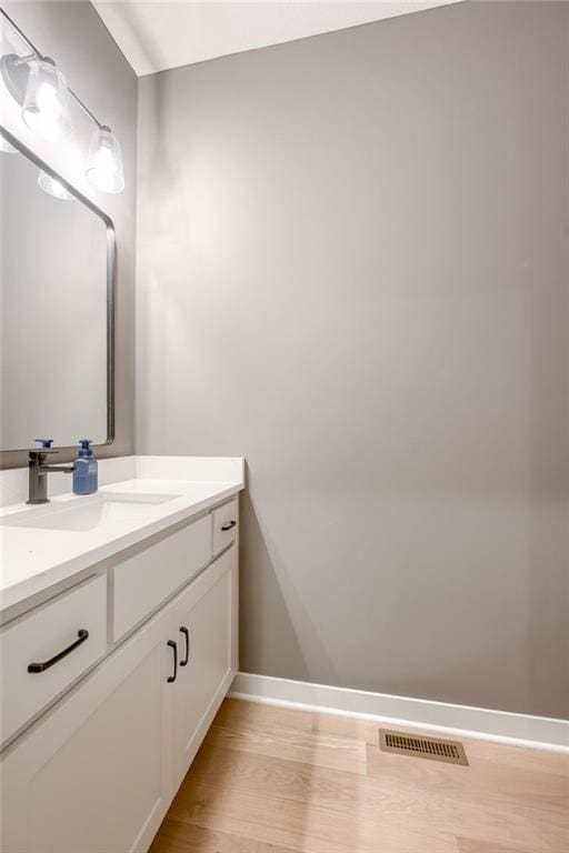 907 Reed Dr, Raymore, MO 64083 - bathroom with vanity and wood finished floors