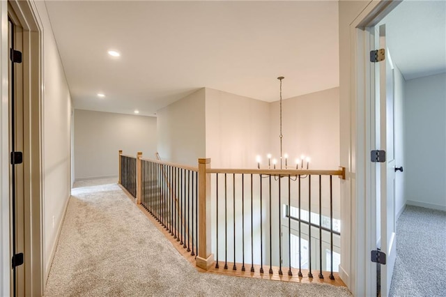 907 Reed Dr, Raymore, MO 64083 - hallway with carpet flooring, a chandelier, and recessed lighting