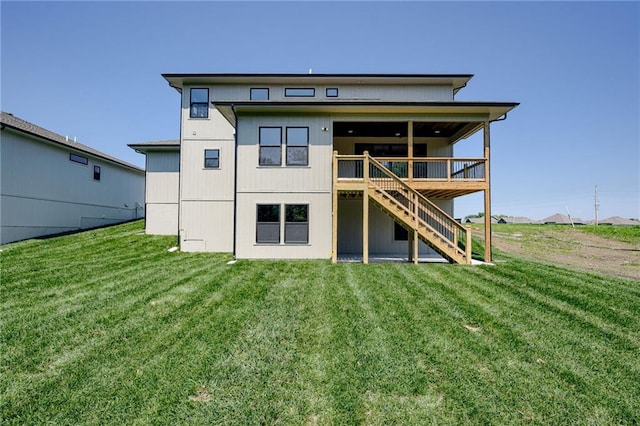 907 Reed Dr, Raymore, MO 64083 - rear view of property featuring stairs, a yard, and a deck