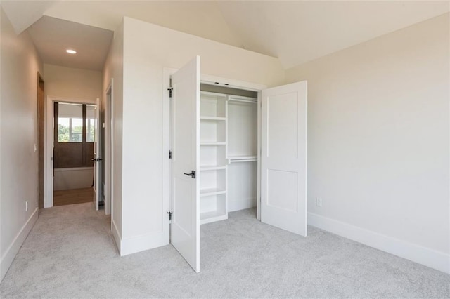 17041 Earnshaw St, Overland Park, KS 66221 - unfurnished bedroom with light carpet, a closet, vaulted ceiling, and recessed lighting