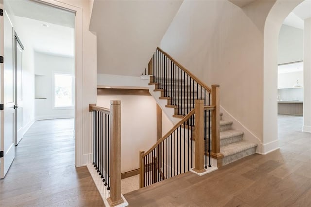 17041 Earnshaw St, Overland Park, KS 66221 - staircase with wood finished floors and arched walkways