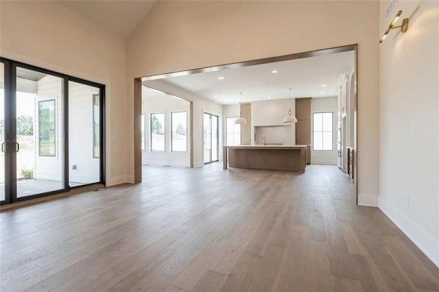 17041 Earnshaw St, Overland Park, KS 66221 - unfurnished living room with wood finished floors and vaulted ceiling
