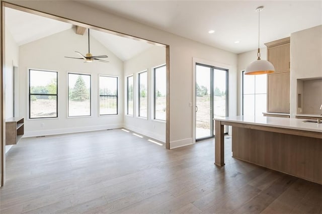 17041 Earnshaw St, Overland Park, KS 66221 - kitchen featuring light countertops, decorative light fixtures, modern cabinets, dark wood-type flooring, and ceiling fan