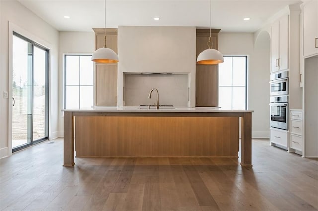 17041 Earnshaw St, Overland Park, KS 66221 - kitchen featuring light wood-style flooring, plenty of natural light, white cabinets, light countertops, and recessed lighting