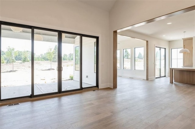 17041 Earnshaw St, Overland Park, KS 66221 - unfurnished living room featuring light wood-style flooring and recessed lighting