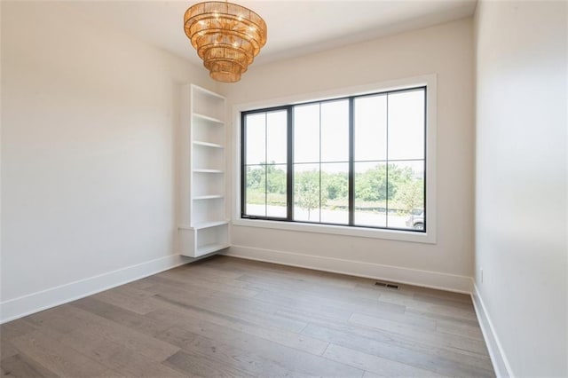 17041 Earnshaw St, Overland Park, KS 66221 - spare room featuring a chandelier and wood finished floors