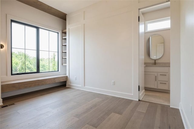 17041 Earnshaw St, Overland Park, KS 66221 - unfurnished bedroom with light wood finished floors, ensuite bathroom, and a closet