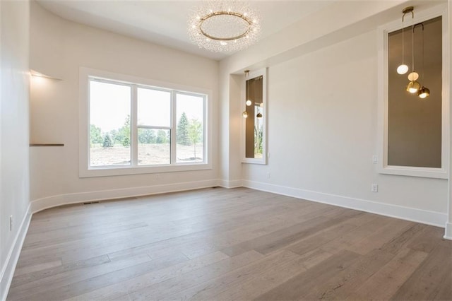 17041 Earnshaw St, Overland Park, KS 66221 - unfurnished room featuring wood finished floors and a chandelier