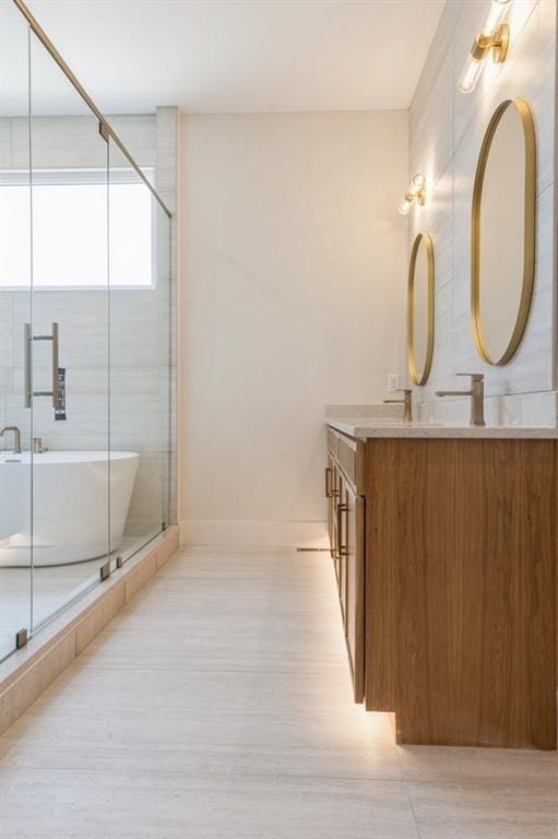 17041 Earnshaw St, Overland Park, KS 66221 - full bathroom featuring double vanity, a freestanding tub, a shower with shower door, and wood finished floors