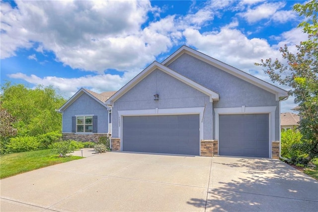 11237 S Race St, Olathe, KS 66061 - ranch-style home with stone siding, stucco siding, a garage, and concrete driveway