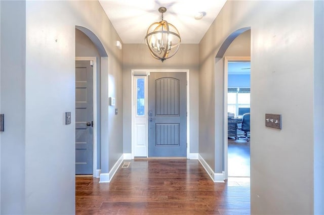 11237 S Race St, Olathe, KS 66061 - foyer entrance featuring arched walkways, wood finished floors, and a chandelier