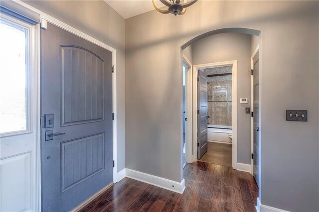 11237 S Race St, Olathe, KS 66061 - foyer entrance with arched walkways and dark wood-style flooring