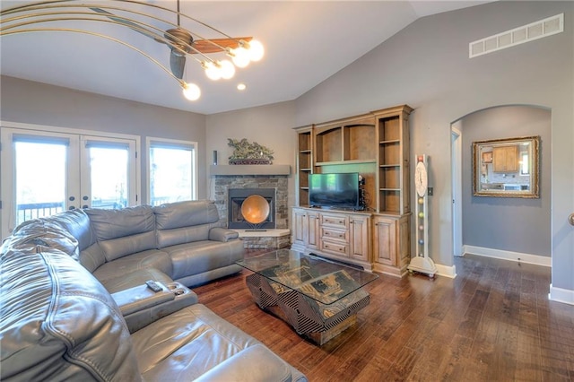11237 S Race St, Olathe, KS 66061 - living area featuring vaulted ceiling, dark wood-style floors, french doors, arched walkways, and a stone fireplace