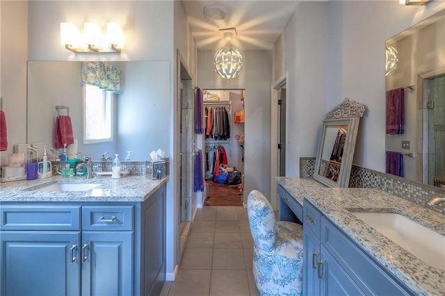 11237 S Race St, Olathe, KS 66061 - full bathroom featuring tile patterned flooring, two vanities, a chandelier, and a stall shower