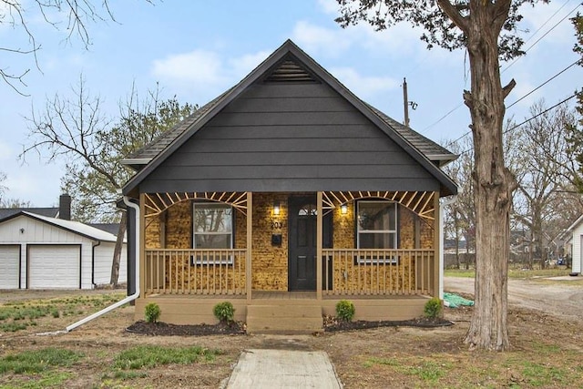 203 N Chestnut St, Pittsburg, KS 66762 - bungalow-style house featuring covered porch, a garage, and an outdoor structure