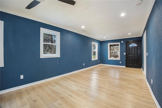 203 N Chestnut St, Pittsburg, KS 66762 - foyer featuring crown molding, a ceiling fan, and a textured wall