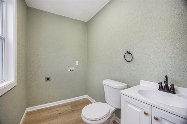 203 N Chestnut St, Pittsburg, KS 66762 - half bath featuring vanity, baseboards, toilet, and wood finished floors