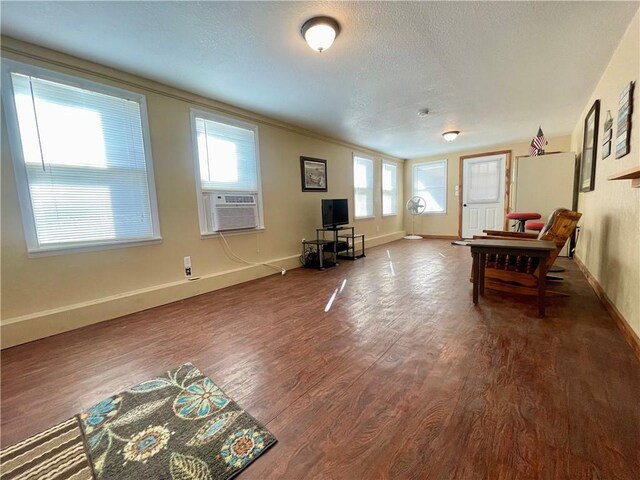 29243 Serene Ave, Warsaw, MO 65355 - living room with wood finished floors, baseboards, cooling unit, a textured ceiling, and crown molding
