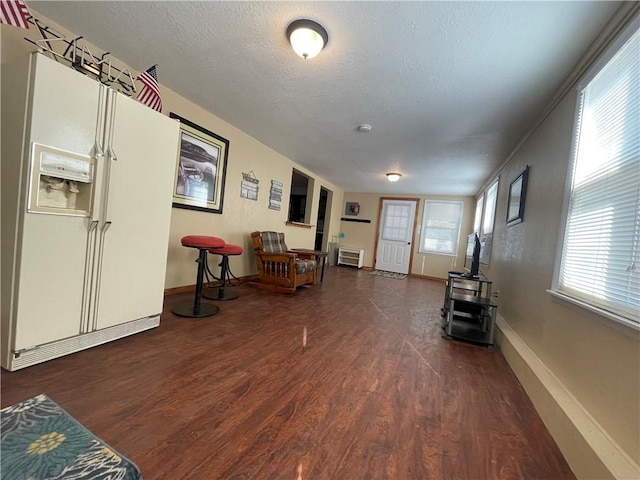 29243 Serene Ave, Warsaw, MO 65355 - sitting room featuring wood finished floors, a textured ceiling, and baseboards