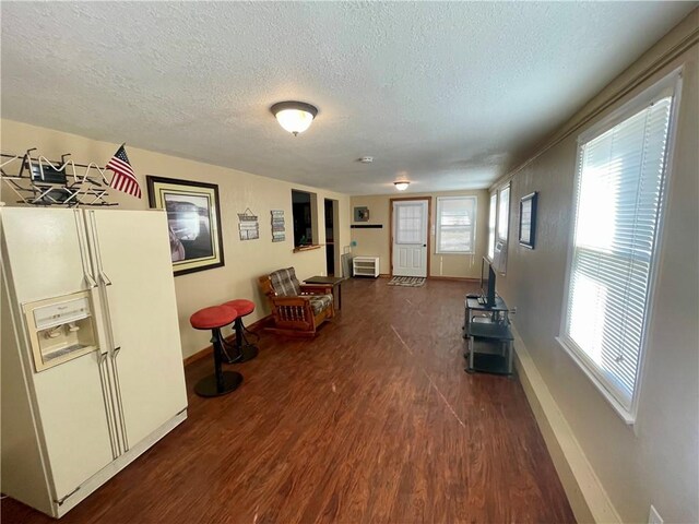 29243 Serene Ave, Warsaw, MO 65355 - sitting room featuring dark wood-style floors, baseboards, and a textured ceiling