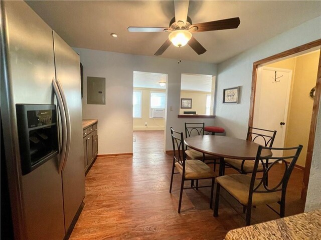 29243 Serene Ave, Warsaw, MO 65355 - dining space with electric panel, ceiling fan, light wood-style floors, cooling unit, and baseboards