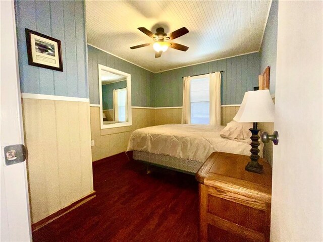 29243 Serene Ave, Warsaw, MO 65355 - bedroom featuring wainscoting, dark wood-type flooring, ceiling fan, and wood walls