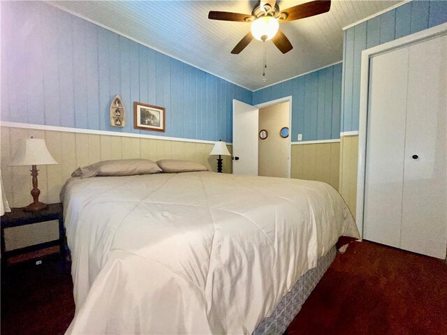 29243 Serene Ave, Warsaw, MO 65355 - carpeted bedroom featuring wood walls, wainscoting, a ceiling fan, and a closet