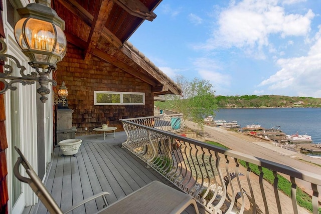 wooden terrace featuring a water view