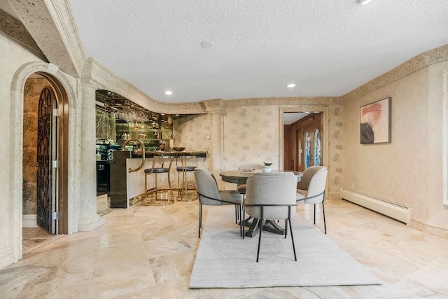 dining space featuring a baseboard radiator, a textured ceiling, arched walkways, and recessed lighting