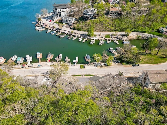 drone / aerial view of a nearby body of water and numerous boat docks