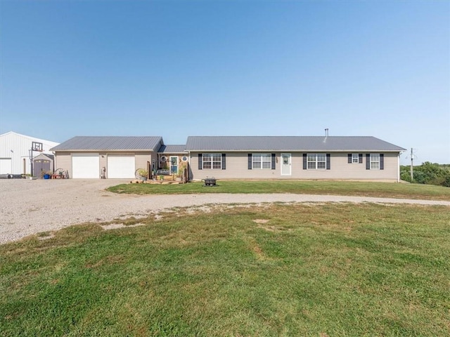 14199 County Road 191, Savannah, MO 64485 - ranch-style home featuring driveway, metal roof, an attached garage, and a front lawn
