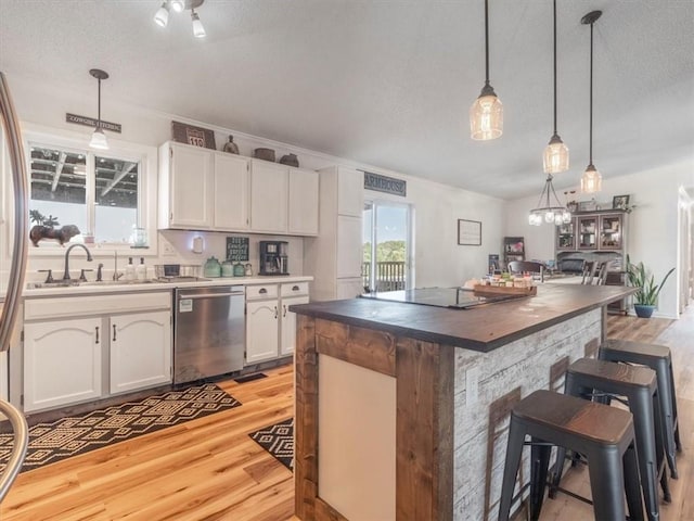 14199 County Road 191, Savannah, MO 64485 - kitchen with a kitchen bar, white cabinets, a sink, dishwasher, and light wood-style flooring