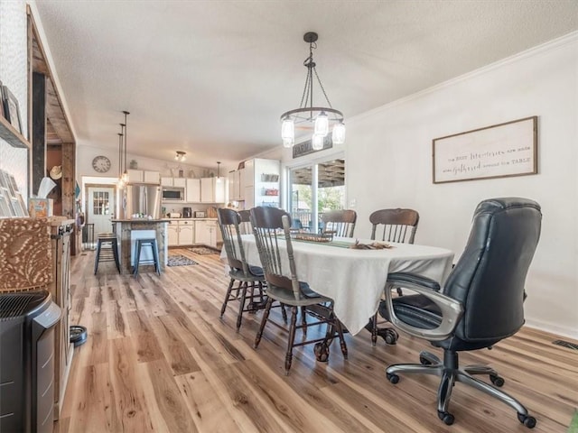 14199 County Road 191, Savannah, MO 64485 - dining space featuring light wood-style flooring, visible vents, ornamental molding, and a textured ceiling