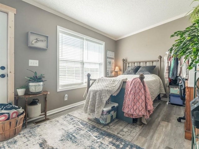 14199 County Road 191, Savannah, MO 64485 - bedroom featuring crown molding, baseboards, a textured ceiling, and wood finished floors
