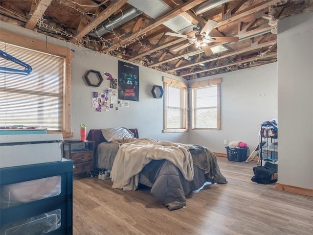 14199 County Road 191, Savannah, MO 64485 - bedroom with multiple windows, ceiling fan, and wood finished floors