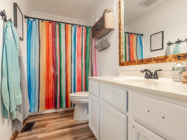 14199 County Road 191, Savannah, MO 64485 - full bathroom featuring visible vents, ornamental molding, toilet, wood finished floors, and vanity