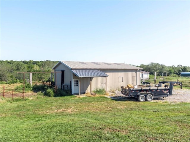 14199 County Road 191, Savannah, MO 64485 - rear view of house with metal roof, an outbuilding, fence, and a pole building