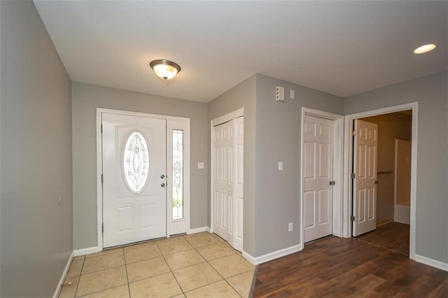 entryway featuring light tile patterned floors and baseboards