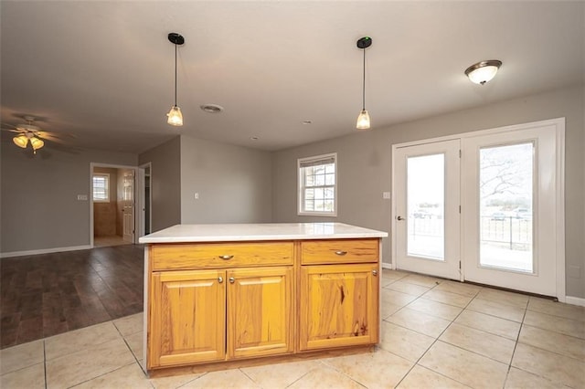 kitchen featuring light tile patterned floors, open floor plan, pendant lighting, and light countertops