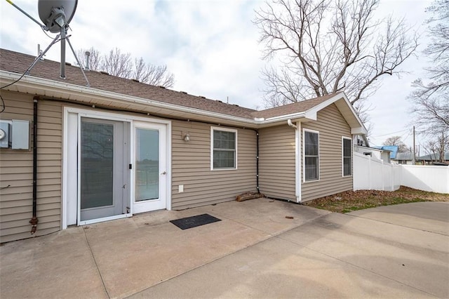 rear view of house featuring a patio area and fence