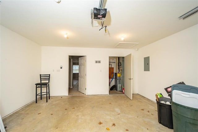 garage featuring electric panel, visible vents, and a garage door opener