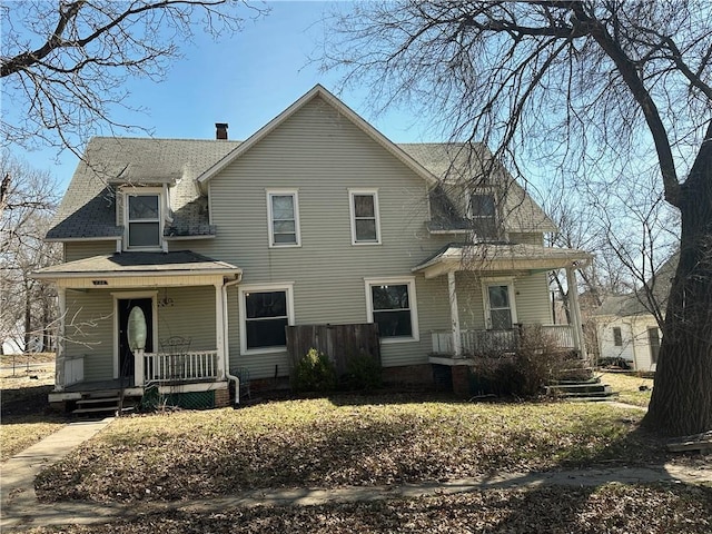 236 N Liberty St, Troy, KS 66087 - view of front of house with roof with shingles, a porch, and a chimney
