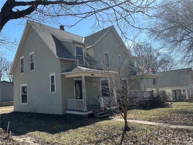 236 N Liberty St, Troy, KS 66087 - view of property exterior featuring roof with shingles, covered porch, and a chimney