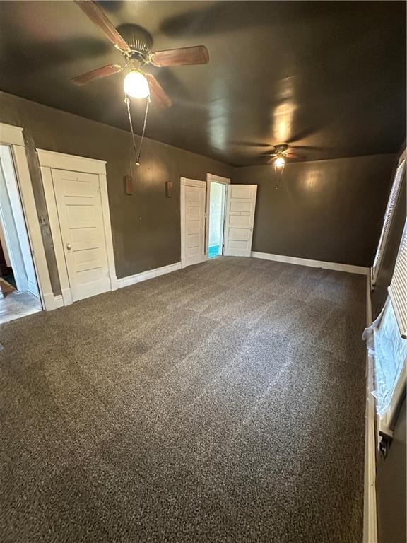 236 N Liberty St, Troy, KS 66087 - unfurnished bedroom featuring carpet flooring, a ceiling fan, and baseboards
