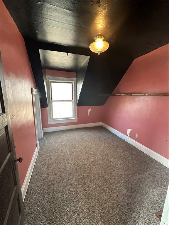 236 N Liberty St, Troy, KS 66087 - bonus room featuring vaulted ceiling, carpet flooring, and baseboards