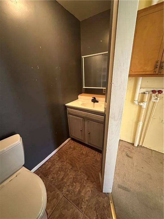 236 N Liberty St, Troy, KS 66087 - bathroom featuring toilet, vanity, and baseboards