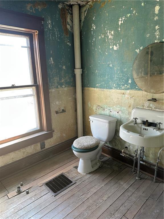 236 N Liberty St, Troy, KS 66087 - bathroom featuring visible vents, hardwood / wood-style floors, wainscoting, and wallpapered walls